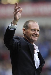 Ex-Rangers' player Paul Gascoigne reacts to the supporters' reception for him at half time during their Scottish Premier League soccer match Ex-Rangers' player Paul Gascoigne reacts to the supporters' reception for him at half time during their Scottish Premier League soccer match