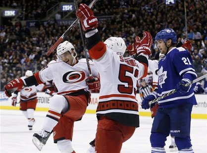 Carolina Hurricanes' Patrick Dwyer (L) celebrates his goal with teammate Jeff Skinner (C) in front of Toronto Maple Leafs' James van Riemsdy Carolina Hurricanes' Patrick Dwyer (L) celebrates his goal with teammate Jeff Skinner (C) in front of Toronto Maple Leafs' James van Riemsdy