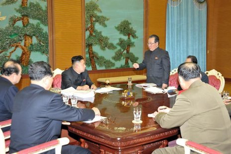North Korean leader Kim Jong-Un (C) presides over a consultative meeting with officials about state security and foreign affairs in this und North Korean leader Kim Jong-Un (C) presides over a consultative meeting with officials about state security and foreign affairs in this und