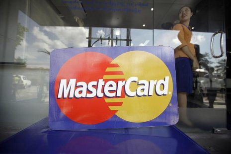 An employee stands behind a MasterCard logo during the launch of the international credit card issuer's first ATM transaction in Myanmar, in An employee stands behind a MasterCard logo during the launch of the international credit card issuer's first ATM transaction in Myanmar, in