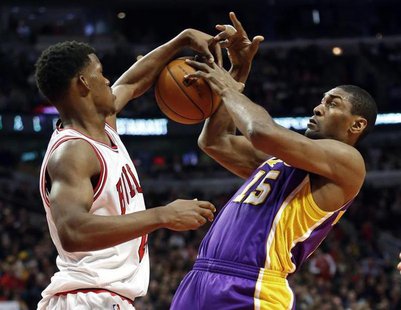 Chicago Bulls small forward Jimmy Butler (L) blocks the shot of Los Angeles Lakers small forward Metta World Peace during the first half of Chicago Bulls small forward Jimmy Butler (L) blocks the shot of Los Angeles Lakers small forward Metta World Peace during the first half of