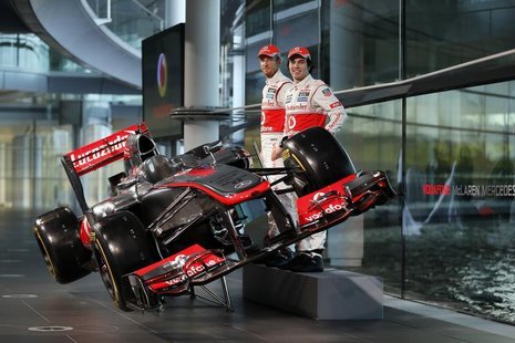 McLaren Formula One drivers Jenson Button of Britain (L) and Sergio Perez of Mexico pose for photographers after unveiling the McLaren MP4-2 McLaren Formula One drivers Jenson Button of Britain (L) and Sergio Perez of Mexico pose for photographers after unveiling the McLaren MP4-2