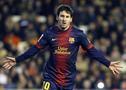 Barcelona's Lionel Messi celebrates after he scored a penalty against Valencia during their Spanish first division soccer match at the Mesta Barcelona's Lionel Messi celebrates after he scored a penalty against Valencia during their Spanish first division soccer match at the Mesta