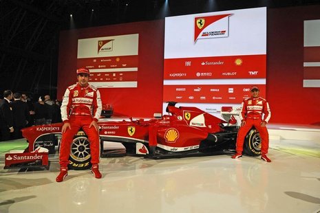 Ferrari Formula One driver Fernando Alonso (L) of Spain and Felipe Massa of Brasil pose near the new Ferrari F138 Formula One car is seen in Ferrari Formula One driver Fernando Alonso (L) of Spain and Felipe Massa of Brasil pose near the new Ferrari F138 Formula One car is seen in