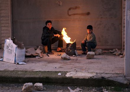 Boys warm up next to a fire outside a building in the Ain Tarma neighbourhood of Damascus February 5, 2013. REUTERS/Goran Tomasevic Boys warm up next to a fire outside a building in the Ain Tarma neighbourhood of Damascus February 5, 2013. REUTERS/Goran Tomasevic