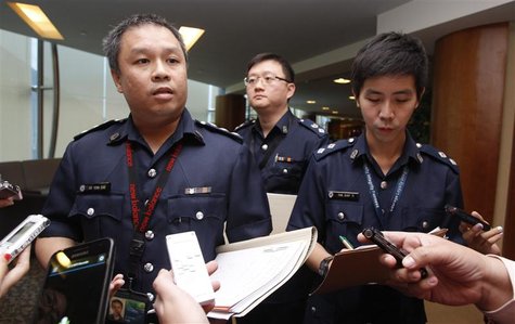 Superintendent Ho Yenn Dar (L), assistant director of media relations of Singapore Police Force listens to questions from journalists on the Superintendent Ho Yenn Dar (L), assistant director of media relations of Singapore Police Force listens to questions from journalists on the
