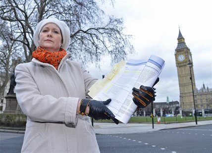 Julie Bailey, the founder of Cure The NHS, holds a copy of the report into the failings at mid-Staffordshire NHS Trust, outside the Houses o Julie Bailey, the founder of Cure The NHS, holds a copy of the report into the failings at mid-Staffordshire NHS Trust, outside the Houses o