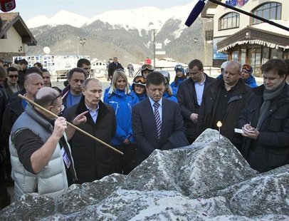 Russia's President Vladimir Putin (2nd L) listens to Interros Company President Vladimir Potanin (L) as he visits the Rosa Khutor Alpine Cen Russia's President Vladimir Putin (2nd L) listens to Interros Company President Vladimir Potanin (L) as he visits the Rosa Khutor Alpine Cen