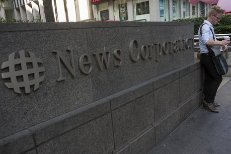 A passer-by stands in front of the News Corporation building in New York June 28, 2012. REUTERS/Keith Bedford A passer-by stands in front of the News Corporation building in New York June 28, 2012. REUTERS/Keith Bedford