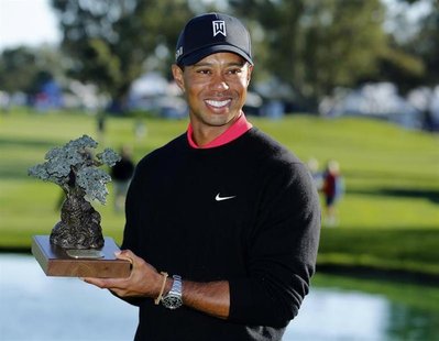 U.S. golfer Tiger Woods holds the trophy after winning the Farmers Insurance Open in San Diego, California January 28, 2013. REUTERS/Mike Bl U.S. golfer Tiger Woods holds the trophy after winning the Farmers Insurance Open in San Diego, California January 28, 2013. REUTERS/Mike Bl