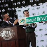 Green Bay Mayor Jim Schmitt unveils "Donald Driver Way" street sign during Lambeau Field retirement ceremony on Feb. 6, 2013.
