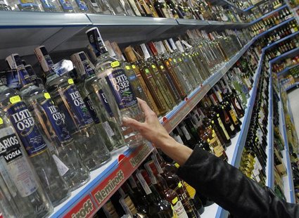 A customer takes a bottle of vodka from a shelf at a Russian supermarket in Benidorm, November 26, 2012. REUTERS/Heino Kalis A customer takes a bottle of vodka from a shelf at a Russian supermarket in Benidorm, November 26, 2012. REUTERS/Heino Kalis