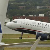 A US airways plane takes off behind an American Airlines jet at Ronald Reagan National Airport in Washington April 23, 2012. REUTERS/Kevin L A US airways plane takes off behind an American Airlines jet at Ronald Reagan National Airport in Washington April 23, 2012. REUTERS/Kevin L