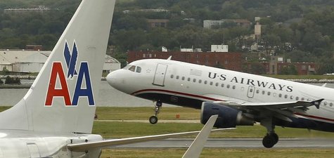 A US airways plane takes off behind an American Airlines jet at Ronald Reagan National Airport in Washington April 23, 2012. REUTERS/Kevin L A US airways plane takes off behind an American Airlines jet at Ronald Reagan National Airport in Washington April 23, 2012. REUTERS/Kevin L