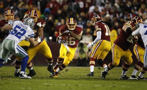 Washington Redskins running back Alfred Morris (C) runs through the Dallas Cowboys line during the first half of their NFL football game in Washington Redskins running back Alfred Morris (C) runs through the Dallas Cowboys line during the first half of their NFL football game in