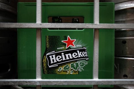 A plastic container with empty bottles of Heineken beers are pictured among beer kegs outside a restaurant in Singapore August 29, 2012. REU A plastic container with empty bottles of Heineken beers are pictured among beer kegs outside a restaurant in Singapore August 29, 2012. REU