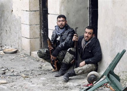 Free Syrian Army fighters carry their weapons as they sit on the ground at the Sheikh Saeed district, near a cement factory in Aleppo, Febru Free Syrian Army fighters carry their weapons as they sit on the ground at the Sheikh Saeed district, near a cement factory in Aleppo, Febru