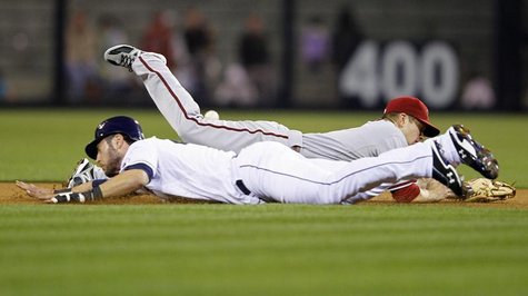 Arizona Diamondbacks' second baseman Aaron Hill (back) dives for the ball as San Diego Padres' right fielder Jeremy Hermida dives for second Arizona Diamondbacks' second baseman Aaron Hill (back) dives for the ball as San Diego Padres' right fielder Jeremy Hermida dives for second
