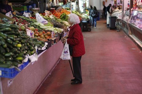 A woman looks at fruits and vegetables at a market stall in Madrid January 29, 2013. REUTERS/Juan Medina A woman looks at fruits and vegetables at a market stall in Madrid January 29, 2013. REUTERS/Juan Medina