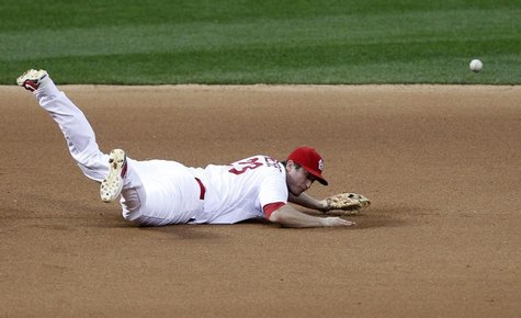 St. Louis Cardinals third baseman David Freese is unable to reach a single by San Francisco Giants' Buster Posey in the seventh inning durin St. Louis Cardinals third baseman David Freese is unable to reach a single by San Francisco Giants' Buster Posey in the seventh inning durin