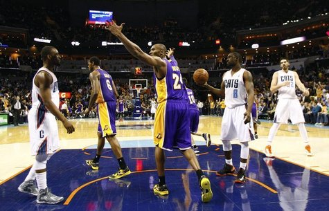 Los Angeles Lakers shooting guard Kobe Bryant (24) reacts after a play against the Charlotte Bobcats during the second half of their NBA bas Los Angeles Lakers shooting guard Kobe Bryant (24) reacts after a play against the Charlotte Bobcats during the second half of their NBA bas