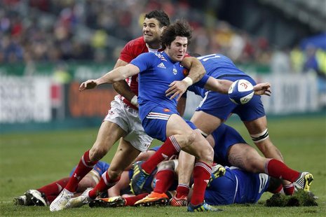 Maxime Machenaud of France (front) struggles with Mike Phillips of Wales (C, rear) during their Six Nations rugby match against France at th Maxime Machenaud of France (front) struggles with Mike Phillips of Wales (C, rear) during their Six Nations rugby match against France at th
