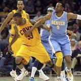 Cleveland Cavaliers Alonzo Gee (33) gets the ball knocked away by Denver Nuggets Andre Iguodala (9) during the first quarter of their NBA ba