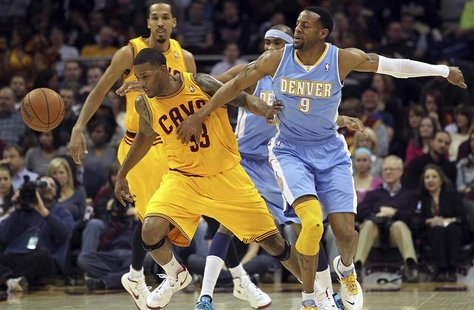 Cleveland Cavaliers Alonzo Gee (33) gets the ball knocked away by Denver Nuggets Andre Iguodala (9) during the first quarter of their NBA ba Cleveland Cavaliers Alonzo Gee (33) gets the ball knocked away by Denver Nuggets Andre Iguodala (9) during the first quarter of their NBA ba