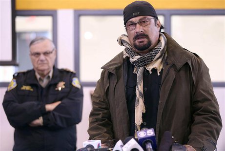 Maricopa County Sheriff Joe Arpaio (L) watches as actor and Maricopa County posse member Steven Seagal addresses the media about a simulated Maricopa County Sheriff Joe Arpaio (L) watches as actor and Maricopa County posse member Steven Seagal addresses the media about a simulated