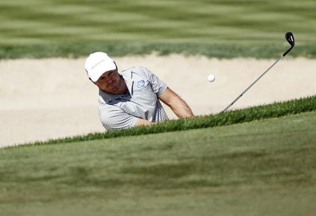 Richard Sterne of South Africa hits out of a bunker at the third green during the fourth and final round of the Dubai Desert Classic at the Richard Sterne of South Africa hits out of a bunker at the third green during the fourth and final round of the Dubai Desert Classic at the