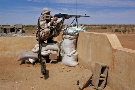 A Tuareg soldier in the Malian army aims his rifle at a checkpoint along a road leading to the border with Niger in the northern city of Gao A Tuareg soldier in the Malian army aims his rifle at a checkpoint along a road leading to the border with Niger in the northern city of Gao