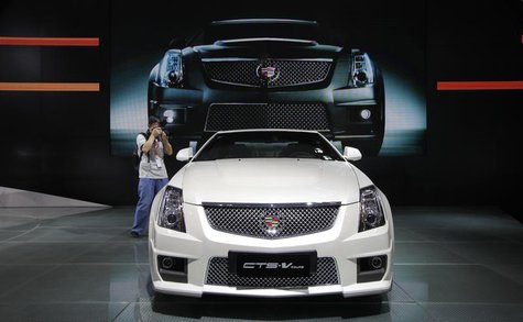 A photographer takes pictures of a Cadillac CTS-V Coupe during the media preview of 10th China International Automobile Exhibition in Guangz A photographer takes pictures of a Cadillac CTS-V Coupe during the media preview of 10th China International Automobile Exhibition in Guangz