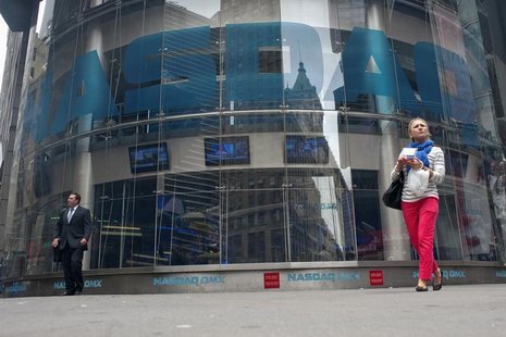 Commuters walk past the NASDAQ MarketSite in New York's Times Square May 22, 2012. REUTERS/Keith Bedford Commuters walk past the NASDAQ MarketSite in New York's Times Square May 22, 2012. REUTERS/Keith Bedford
