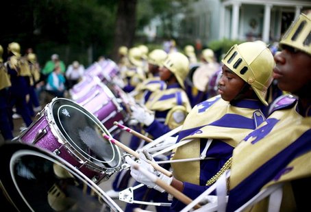 Members of the St. Augustine High School band march down St. Charles Avenue as the Krewe of Mid-City parades during the weekend before Mardi Members of the St. Augustine High School band march down St. Charles Avenue as the Krewe of Mid-City parades during the weekend before Mardi