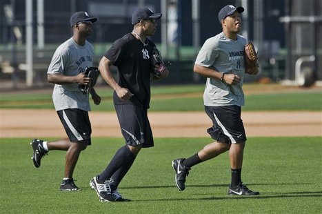 New York Yankees outfielders (from L) Melky Mesa, Curtis Granderson and Thomas Neal take to the field during an informal workout at the team New York Yankees outfielders (from L) Melky Mesa, Curtis Granderson and Thomas Neal take to the field during an informal workout at the team