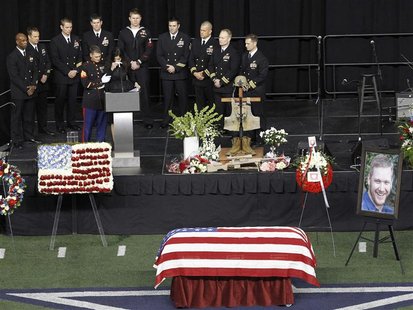 Taya Kyle is steadied by a Marine while addressing friends and family during a memorial service for slain husband and former Navy SEAL snipe Taya Kyle is steadied by a Marine while addressing friends and family during a memorial service for slain husband and former Navy SEAL snipe