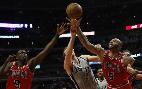Chicago Bulls' Carlos Boozer (R) and teammate Luol Deng (L) battle San Antonio Spurs' Matt Bonner for a rebound during the first half of the Chicago Bulls' Carlos Boozer (R) and teammate Luol Deng (L) battle San Antonio Spurs' Matt Bonner for a rebound during the first half of the