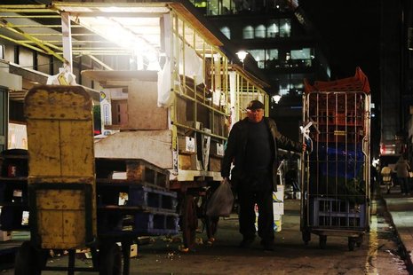 A market trader packs up his stall in London November 13, 2012. REUTERS/Luke MacGregor A market trader packs up his stall in London November 13, 2012. REUTERS/Luke MacGregor