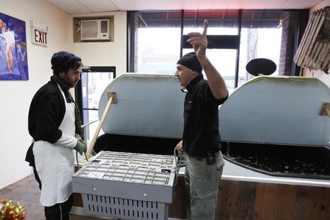 Small-business owner Ralph Gorham (R) speaks to employee Elijah Ocean at his shop "Redhook Lobster Pound" in New York December 16, 2010. REU Small-business owner Ralph Gorham (R) speaks to employee Elijah Ocean at his shop "Redhook Lobster Pound" in New York December 16, 2010. REU