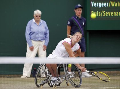 Esther Vergeer of the Netherlands serves, with her partner Sharon Walraven of the Netherlands (UNSEEN), to Marjolein Buis of the Netherlands Esther Vergeer of the Netherlands serves, with her partner Sharon Walraven of the Netherlands (UNSEEN), to Marjolein Buis of the Netherlands