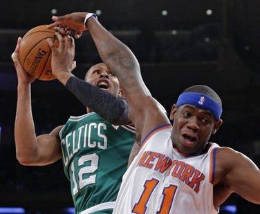New York Knicks forward Ronnie Brewer (11) fouls Boston Celtics guard Leandro Barbosa (12) in the second quarter of their NBA basketball gam New York Knicks forward Ronnie Brewer (11) fouls Boston Celtics guard Leandro Barbosa (12) in the second quarter of their NBA basketball gam