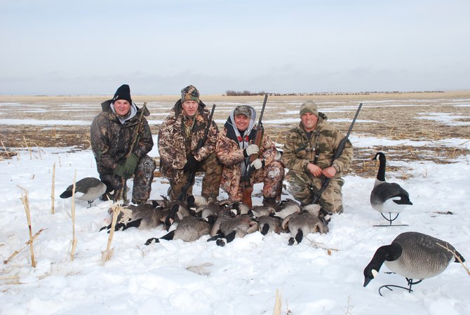 Outdoorsmen Adventure TV host Gary Howey with team members Tom Mitchell and Larry Myhre. Guide Paul Steffen after a successful South Dakota late season goose hunt.