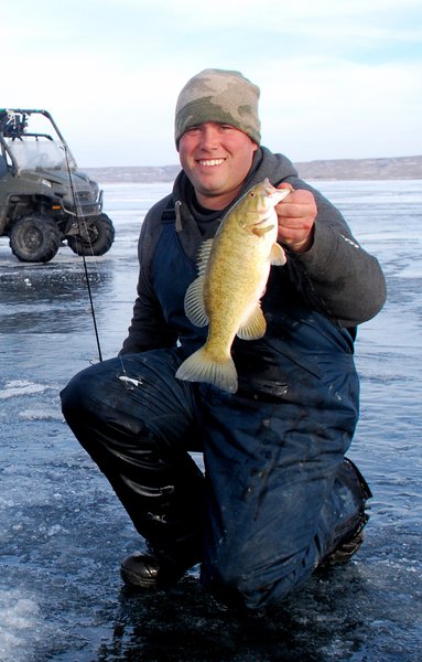 Guide Paul Steffen with a nice small mouth bass taken through the ice on Lake Oahe