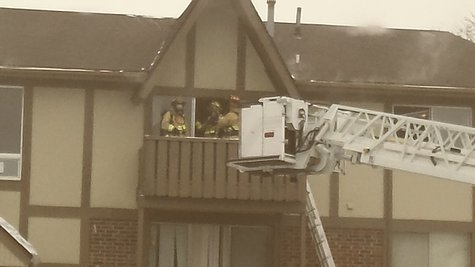 Firefighters on third story balcony Firefighters on third story balcony