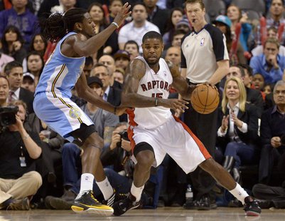 Toronto Raptors Amir Johnson (R) moves around Denver Nuggets Kenneth Faried during the second half of their NBA basketball game in Toronto F Toronto Raptors Amir Johnson (R) moves around Denver Nuggets Kenneth Faried during the second half of their NBA basketball game in Toronto F