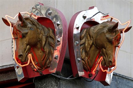 Metal horse heads outlined with neon lights are seen above a horsemeat butcher shop in Paris in this February 11, 2013 file picture. REUTERS Metal horse heads outlined with neon lights are seen above a horsemeat butcher shop in Paris in this February 11, 2013 file picture. REUTERS