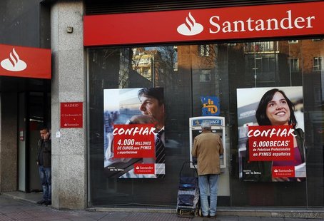 A man uses an ATM machine as another talks on the phone outside a Santander bank branch in Madrid January 31, 2013. REUTERS/Susana Vera A man uses an ATM machine as another talks on the phone outside a Santander bank branch in Madrid January 31, 2013. REUTERS/Susana Vera