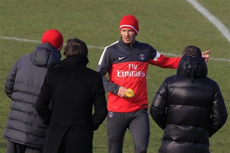 Paris Saint Germain's soccer player David Beckham (2ndR) speaks with Paris St-Germain sports director Leonardo (2ndL) and coach Carlo Ancelo Paris Saint Germain's soccer player David Beckham (2ndR) speaks with Paris St-Germain sports director Leonardo (2ndL) and coach Carlo Ancelo