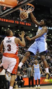 Denver Nuggets Kenneth Faried (R) dunks over Toronto Raptors Kyle Lowry during the second half of their NBA basketball game in Toronto Febru Denver Nuggets Kenneth Faried (R) dunks over Toronto Raptors Kyle Lowry during the second half of their NBA basketball game in Toronto Febru