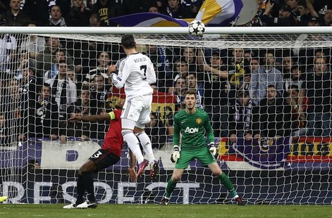 Real Madrid's Cristiano Ronaldo scores past Manchester United goalkeeper David De Gea (R) during their Champions League soccer match at Sant Real Madrid's Cristiano Ronaldo scores past Manchester United goalkeeper David De Gea (R) during their Champions League soccer match at Sant